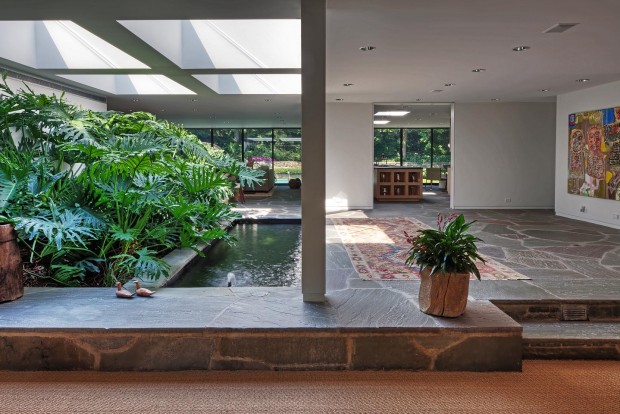 an arboretum in the foyer -- complete with a koi pond -- all lit from above via massive skylights, photographed by Jacob Rosenfeld